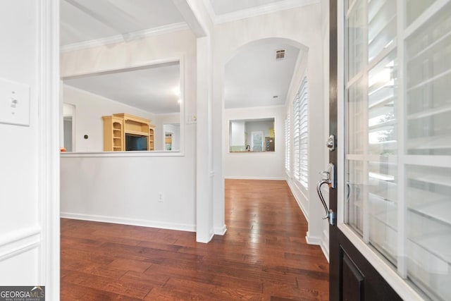 foyer entrance with dark hardwood / wood-style floors and ornamental molding