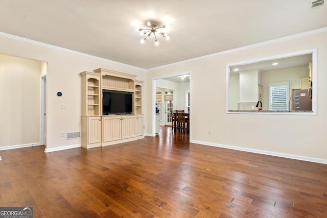 unfurnished living room with a chandelier, dark hardwood / wood-style floors, and ornamental molding