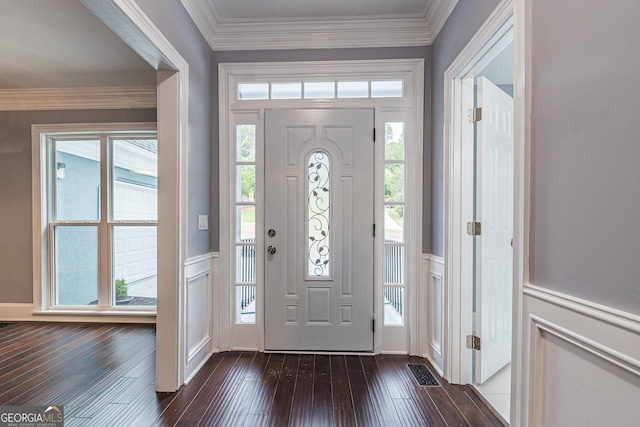 entryway with ornamental molding and dark wood-type flooring