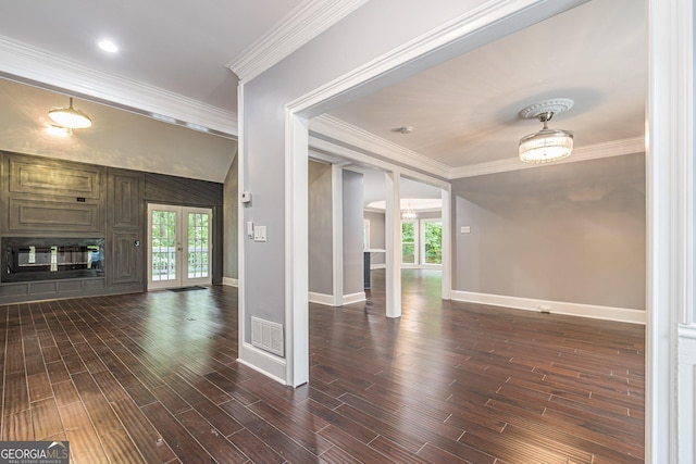 unfurnished living room featuring crown molding, plenty of natural light, and french doors