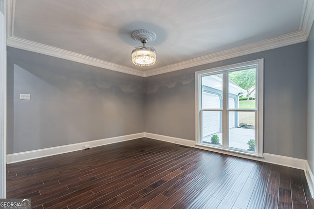 empty room featuring wood-type flooring and crown molding