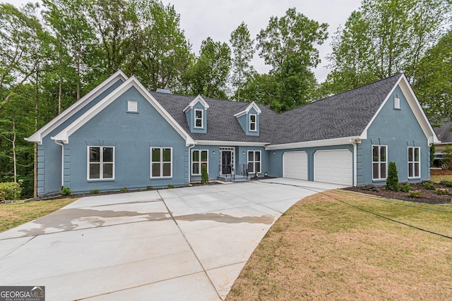 cape cod house with a garage and a front yard