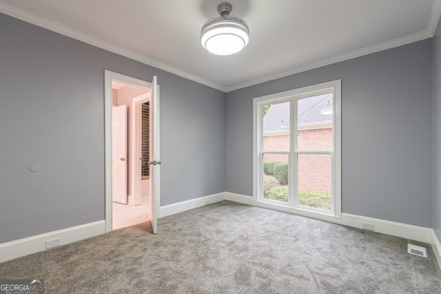 carpeted spare room with crown molding