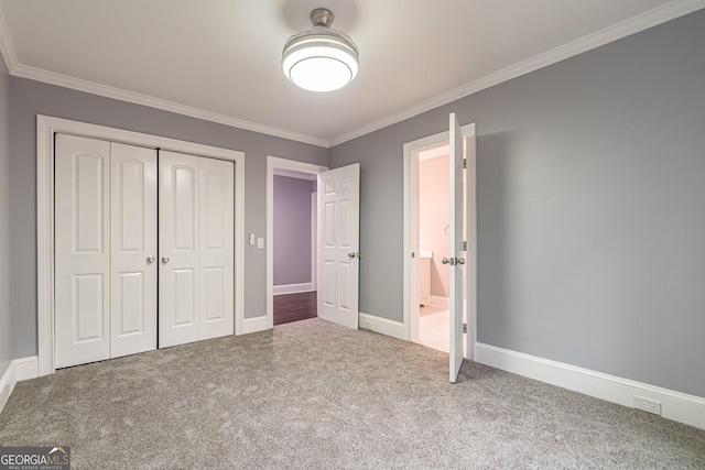 unfurnished bedroom featuring carpet, ornamental molding, and a closet