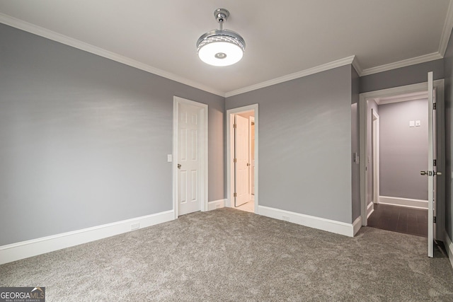 unfurnished bedroom featuring dark carpet and ornamental molding