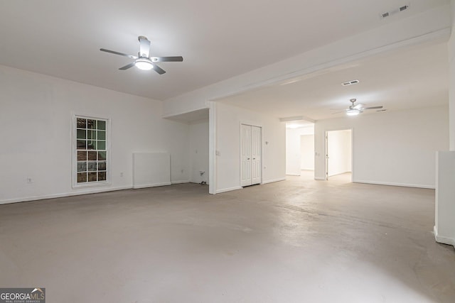 spare room with ceiling fan and concrete flooring