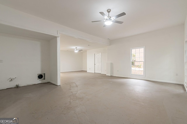 spare room featuring ceiling fan and concrete floors