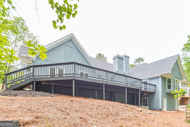 rear view of property featuring a wooden deck