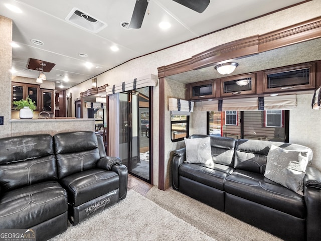 home theater room featuring light hardwood / wood-style flooring and ceiling fan