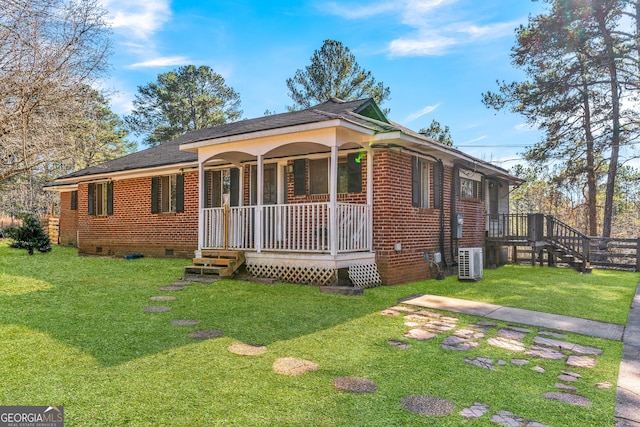 ranch-style house featuring central AC, a front yard, and covered porch