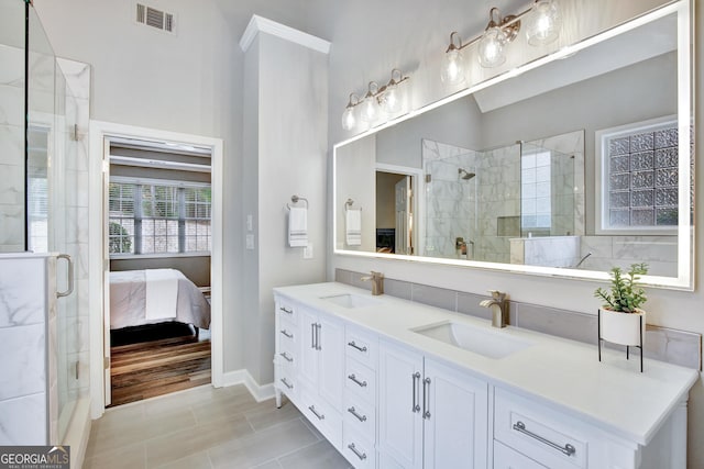 bathroom featuring tile patterned floors, a shower with door, and vanity