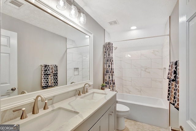 full bathroom with shower / bath combination with curtain, vanity, and toilet