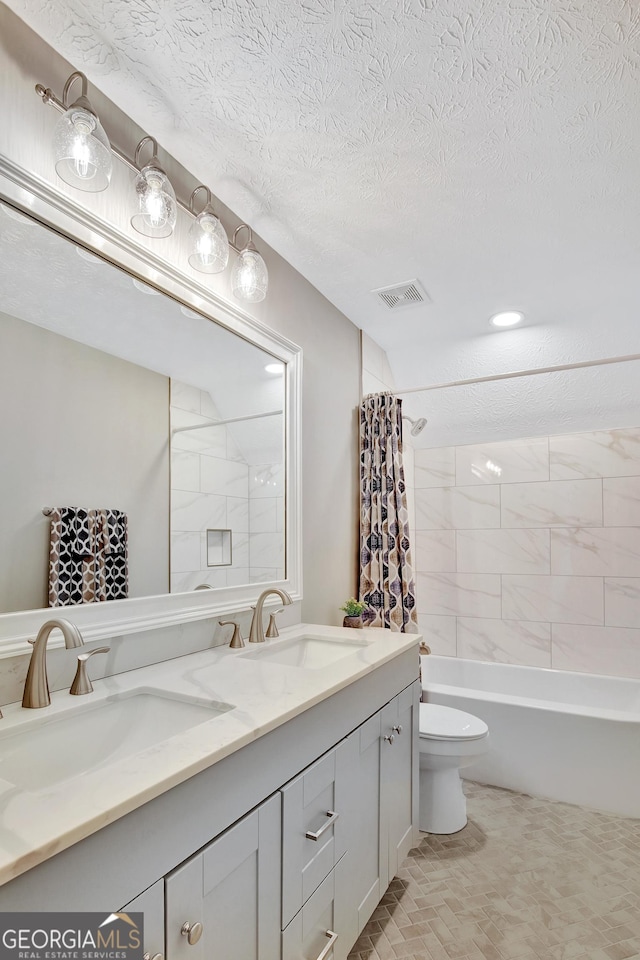 full bathroom with vanity, a textured ceiling, toilet, and shower / bathtub combination with curtain