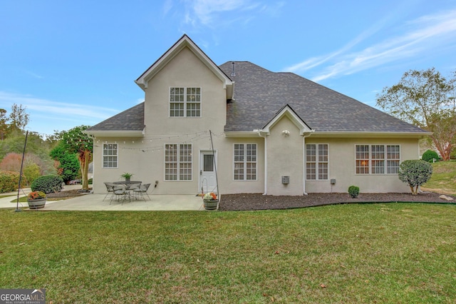 back of property with a lawn and a patio area