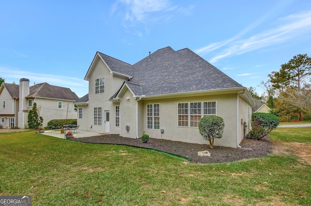 rear view of house with a patio area and a yard