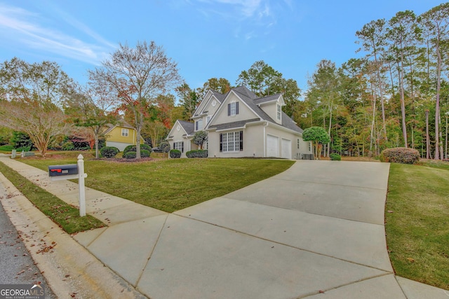 view of front of property featuring a garage and a front lawn