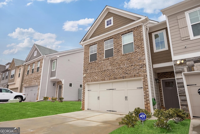 townhome / multi-family property with a garage and a front yard