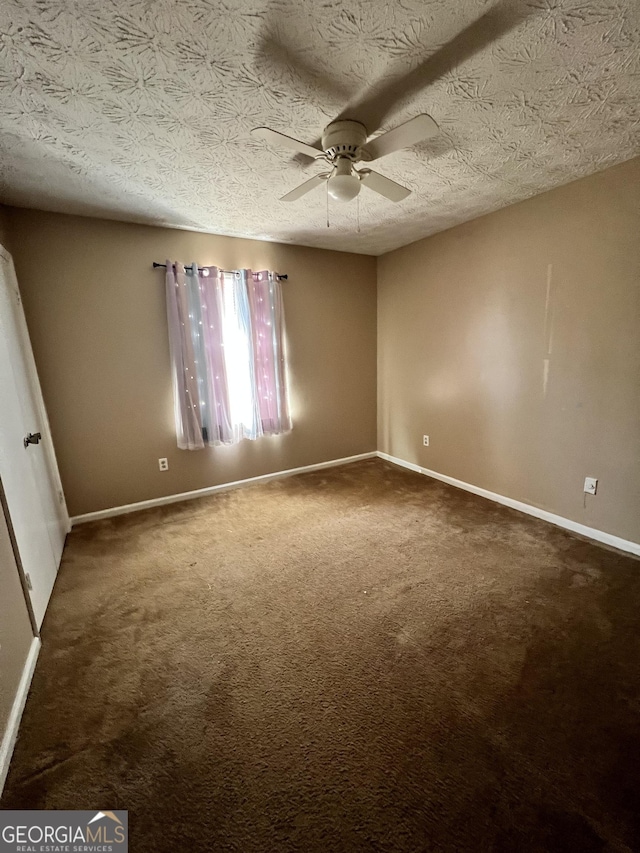 carpeted spare room with ceiling fan and a textured ceiling