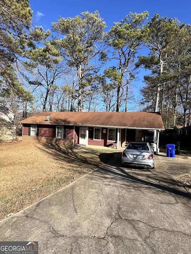 single story home with a front lawn and a carport