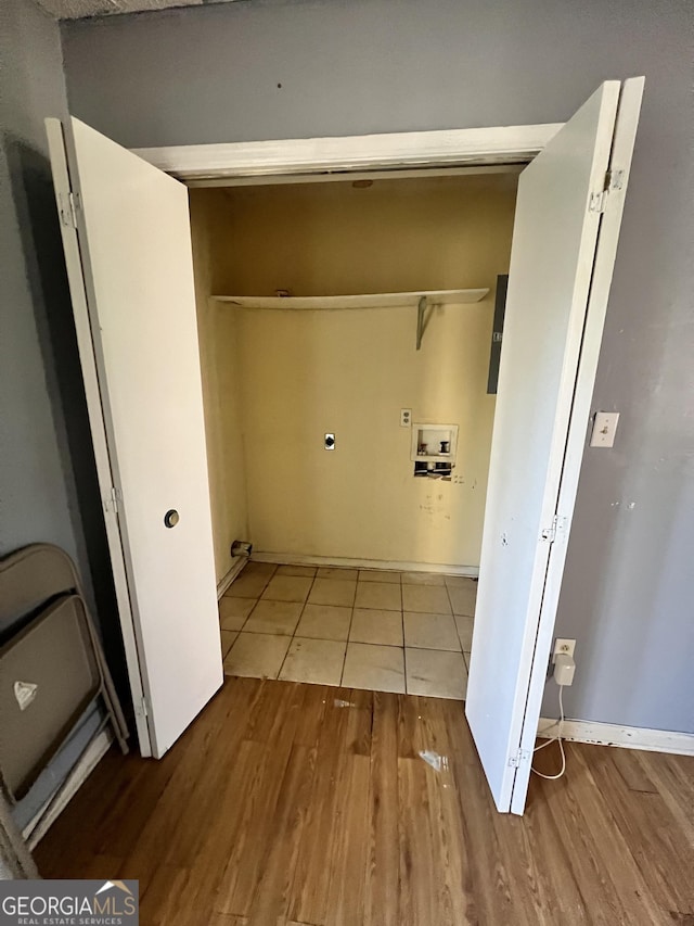 clothes washing area featuring hookup for a washing machine and light hardwood / wood-style floors