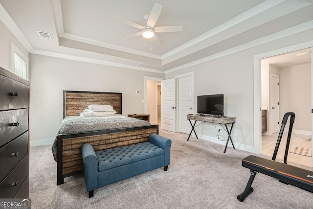 carpeted bedroom featuring a tray ceiling, ceiling fan, and ornamental molding