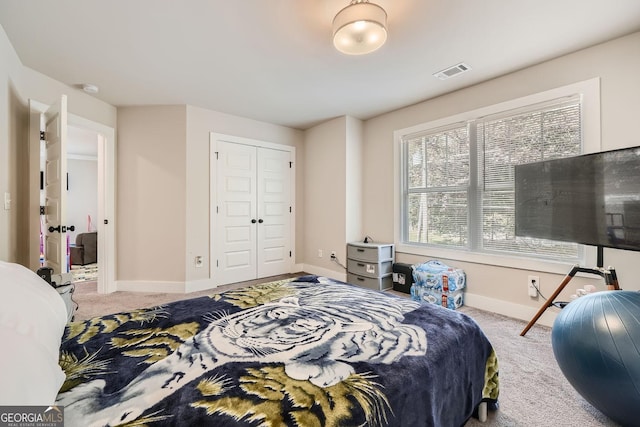 bedroom with light colored carpet and a closet