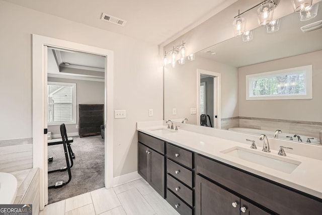 bathroom featuring a tub, tile patterned flooring, and vanity