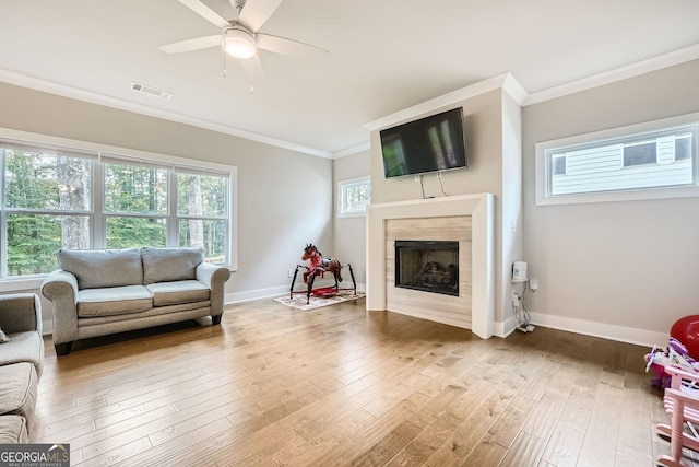 living room featuring ceiling fan, hardwood / wood-style floors, and ornamental molding