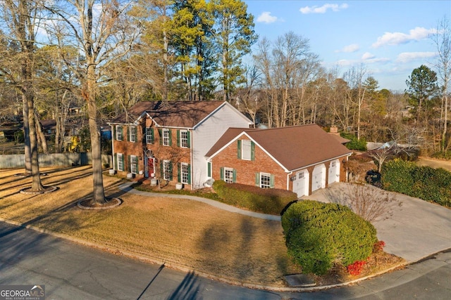 view of front of home featuring a front yard and a garage