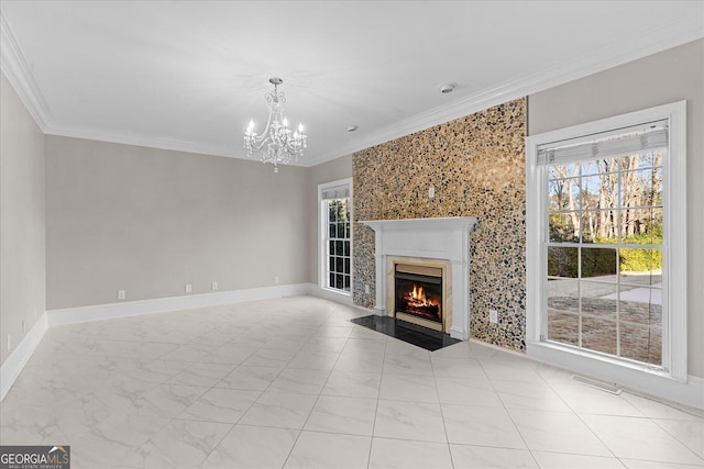 unfurnished living room with crown molding, a fireplace, and an inviting chandelier