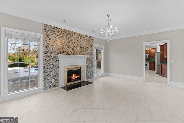 unfurnished living room featuring a notable chandelier, crown molding, and a high end fireplace