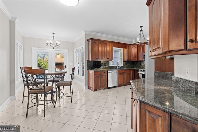 kitchen with light tile patterned floors, tasteful backsplash, decorative light fixtures, stainless steel appliances, and a chandelier