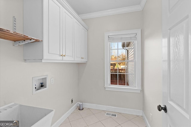 washroom with hookup for a washing machine, light tile patterned flooring, cabinets, and ornamental molding