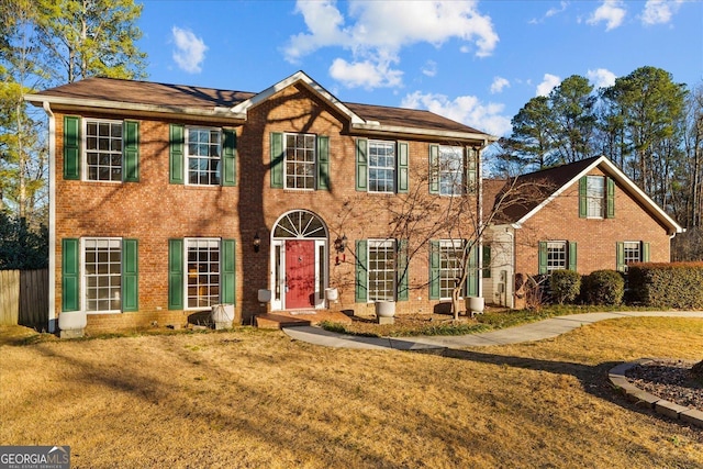 colonial inspired home featuring a front yard