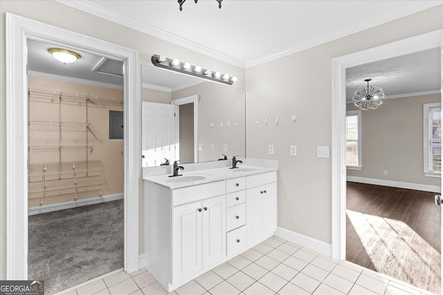 bathroom with tile patterned flooring, vanity, an inviting chandelier, and ornamental molding