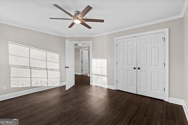 unfurnished bedroom featuring a closet, ceiling fan, crown molding, and dark hardwood / wood-style floors