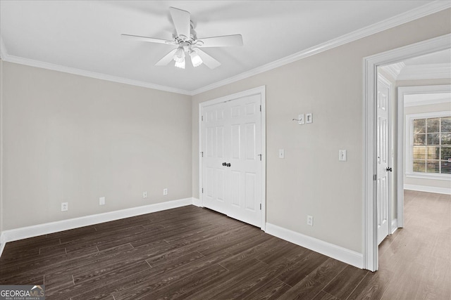 empty room featuring dark hardwood / wood-style flooring, ceiling fan, and ornamental molding