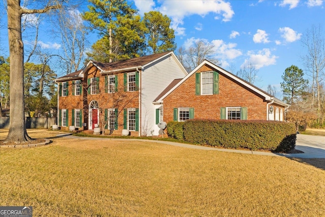 colonial home featuring a front lawn