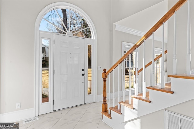 foyer featuring ornamental molding