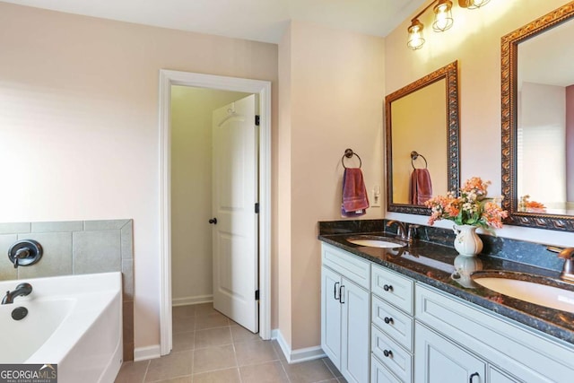 bathroom with tile patterned floors, vanity, and a bath