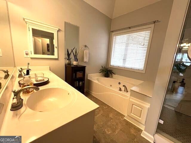 bathroom featuring vanity and shower with separate bathtub