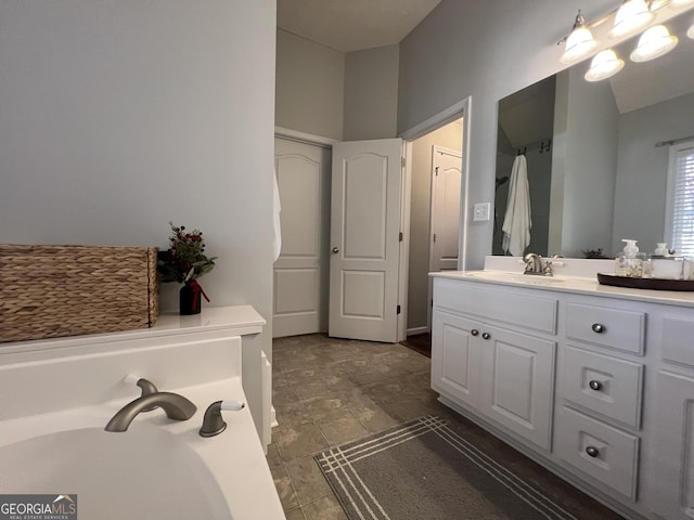 bathroom featuring vanity and a bath