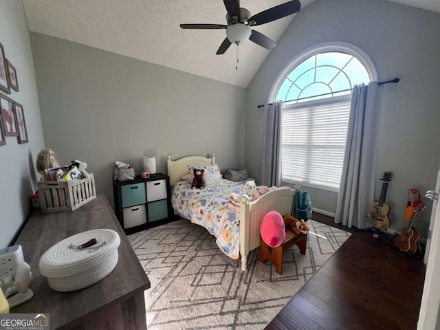 bedroom featuring ceiling fan, lofted ceiling, hardwood / wood-style floors, and a textured ceiling