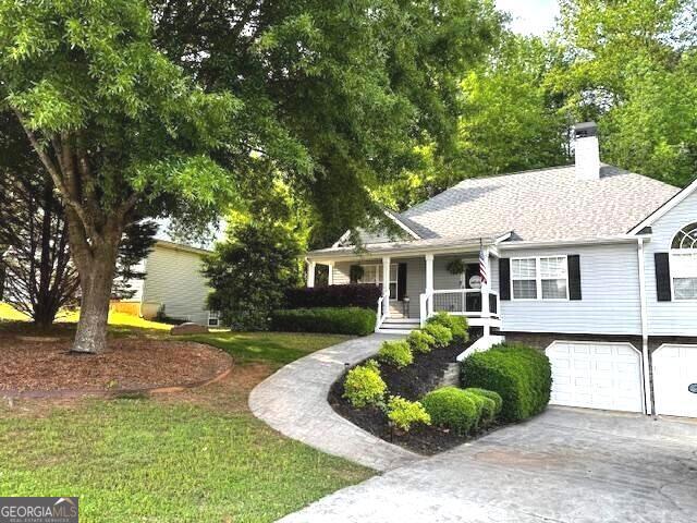 213 Moore Valley Way, Canton, GA 30115 - view of front of home featuring a chimney, a porch, driveway, and an attached garage