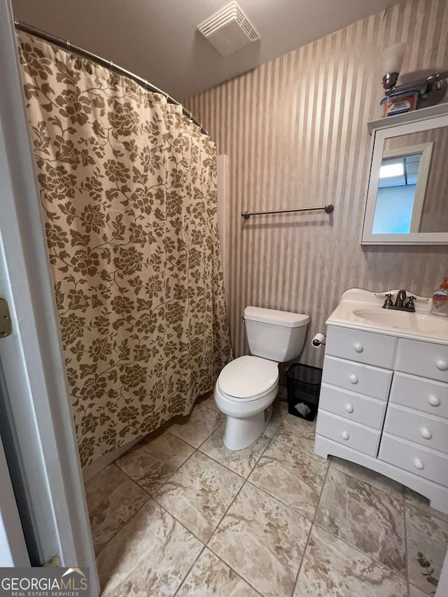 bathroom with vanity and toilet