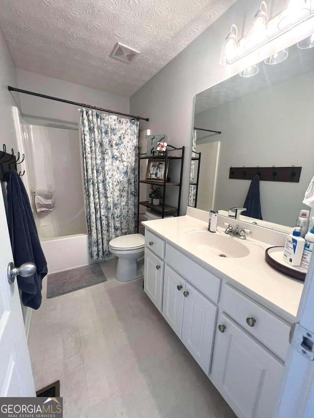 213 Moore Valley Way, Canton, GA 30115 - bathroom featuring vanity, shower / bath combo, a textured ceiling, and tile patterned floors