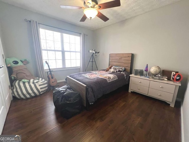 213 Moore Valley Way, Canton, GA 30115 - bedroom featuring dark wood-type flooring, a textured ceiling, ceiling fan, and baseboards