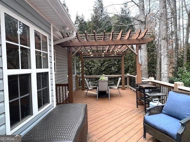 wooden deck featuring a pergola