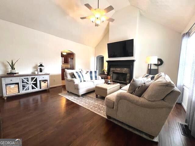 213 Moore Valley Way, Canton, GA 30115 - living area featuring arched walkways, a fireplace, ceiling fan, wood finished floors, and baseboards