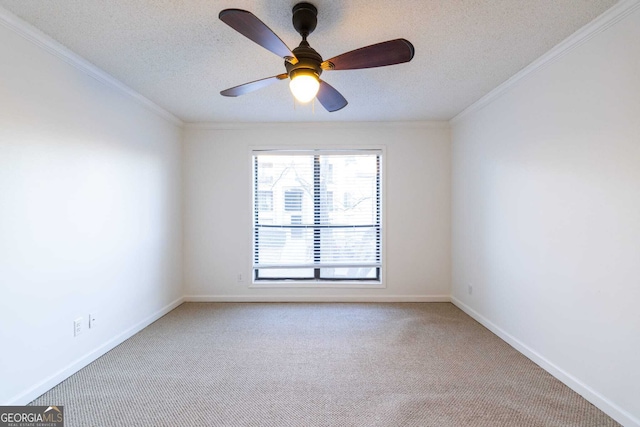 carpeted spare room with a textured ceiling, ceiling fan, and crown molding